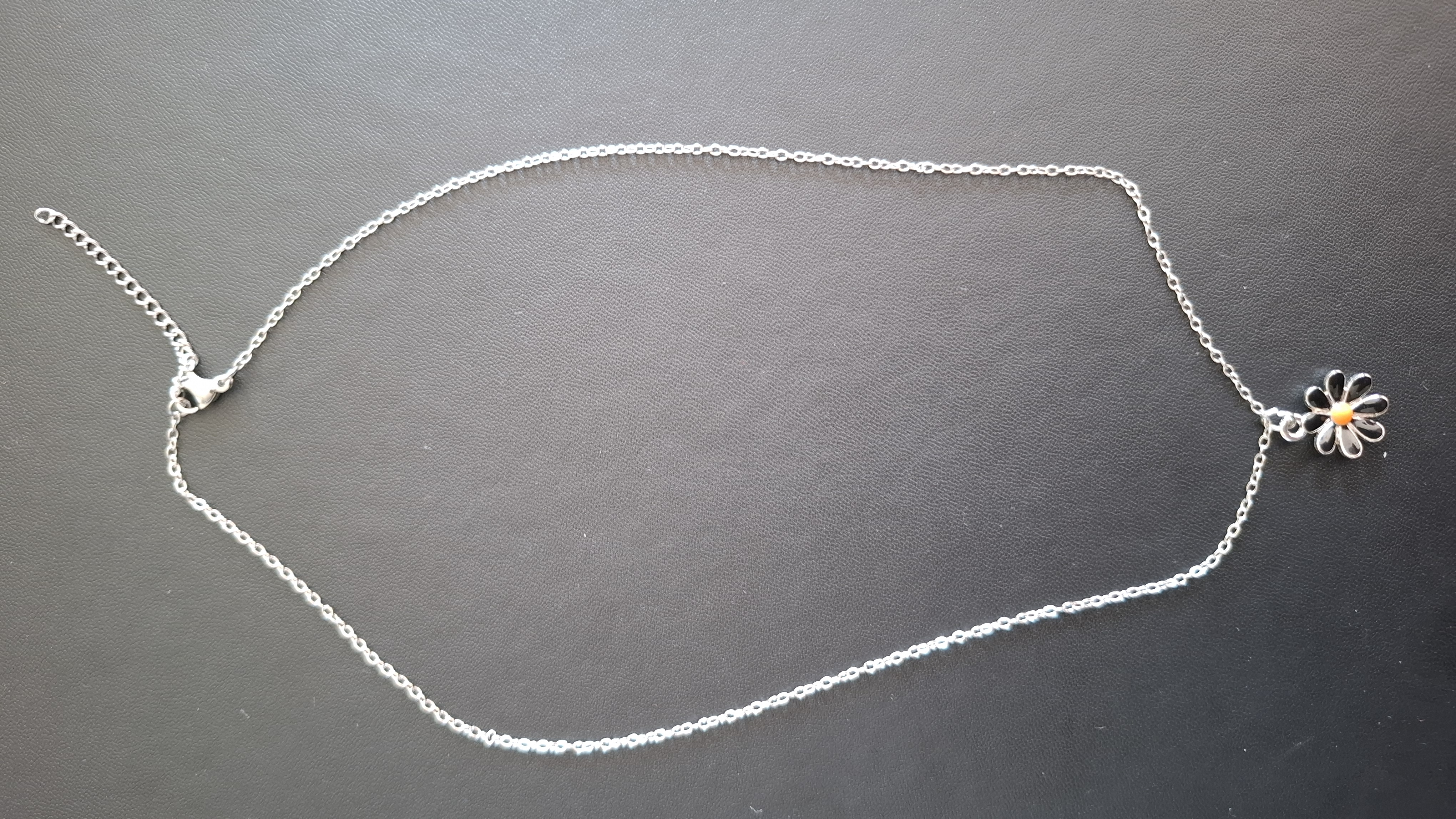 ketting in zilveren kleur met zwarte bloem